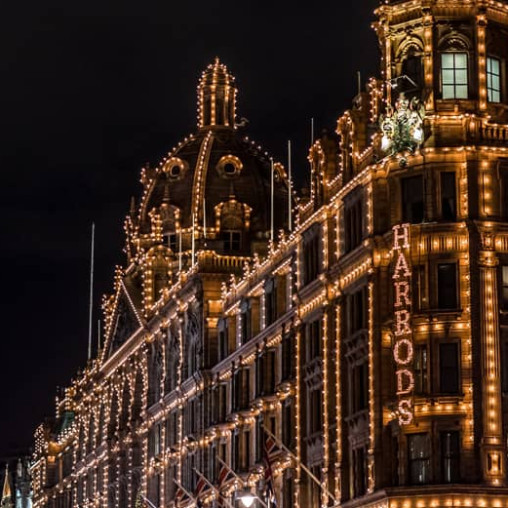 Harrods store in London lit up at night.